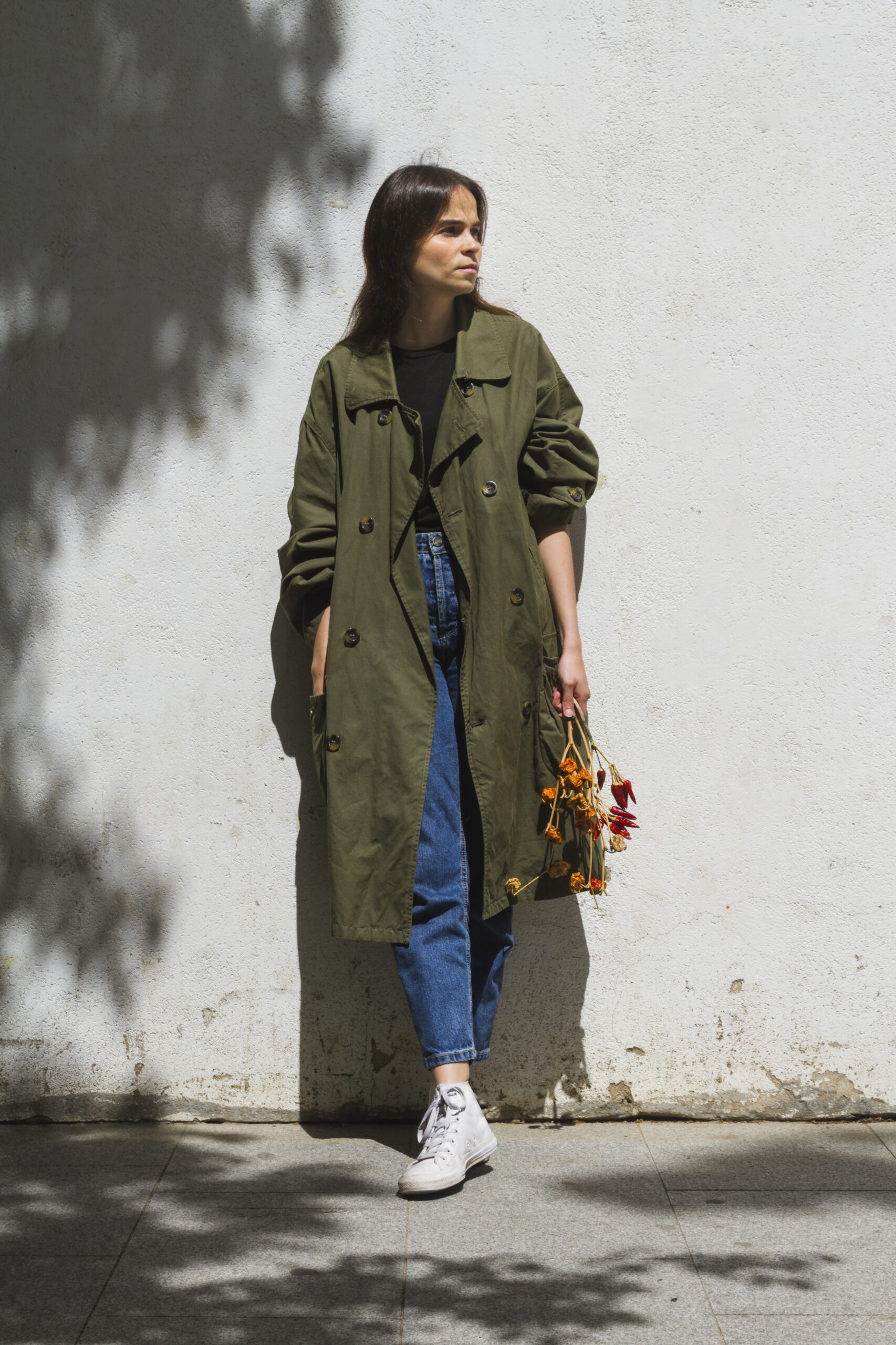 long-shot-standing-woman-holding-bunch-peppers